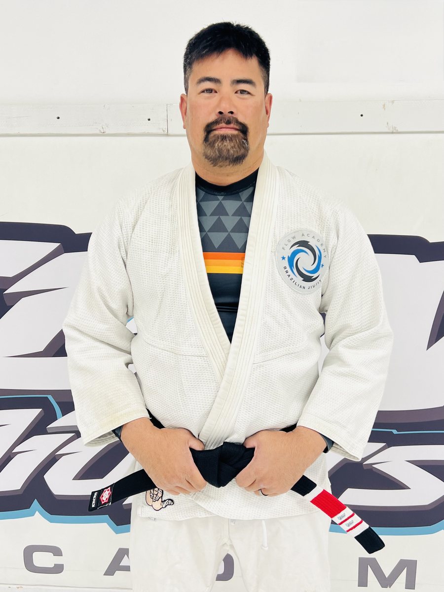 Professor Ron Ishikawa, 2nd-degree black belt, in a white Flow Academy gi