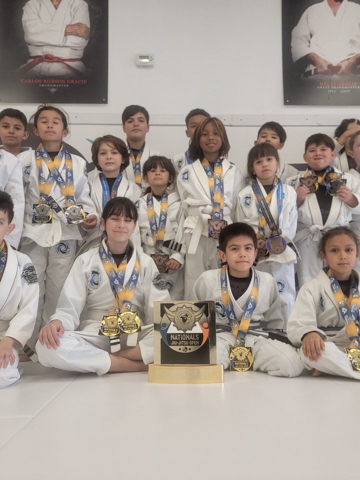 Kids Brazilian Jiu-Jitsu student earning her yellow belt at Flow Academy Indio